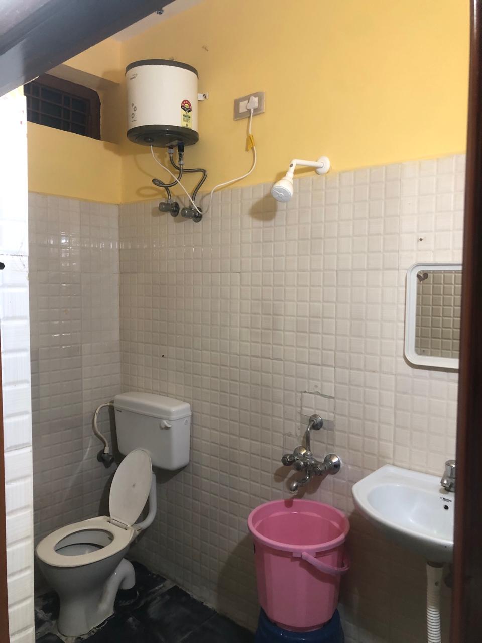 Bathroom with geyser and sink